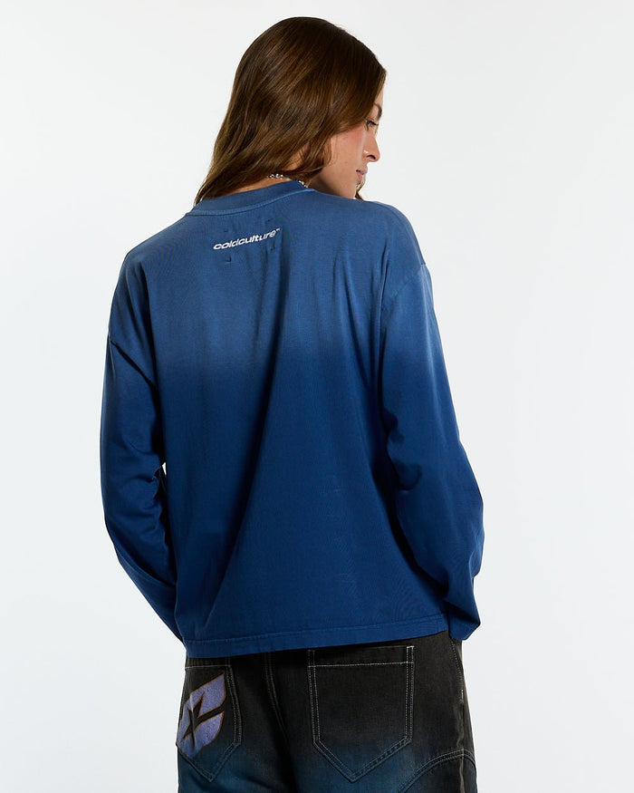 CROSSED SCRIPT LONGSLEEVE VIBRANT BLUE - washed blue script print longsleeve tee, back view on female model - Cold Culture #woman