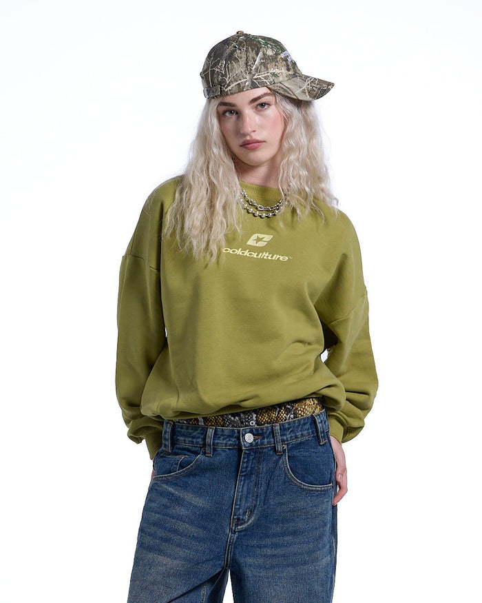 CURVED CREWNECK LIGHT GREEN - light green oversized crewneck sweatshirt, front view on female model - Cold Culture #woman