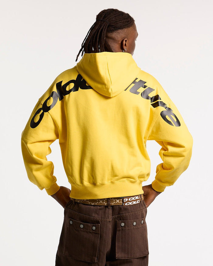 CURVED HOODIE YELLOW - yellow logo print hoodie, back view on male model - Cold Culture #man