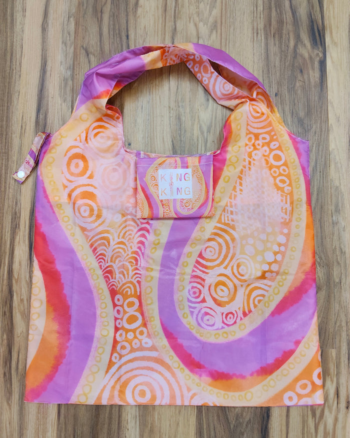 Colorful Aboriginal patterned bag on a wooden surface