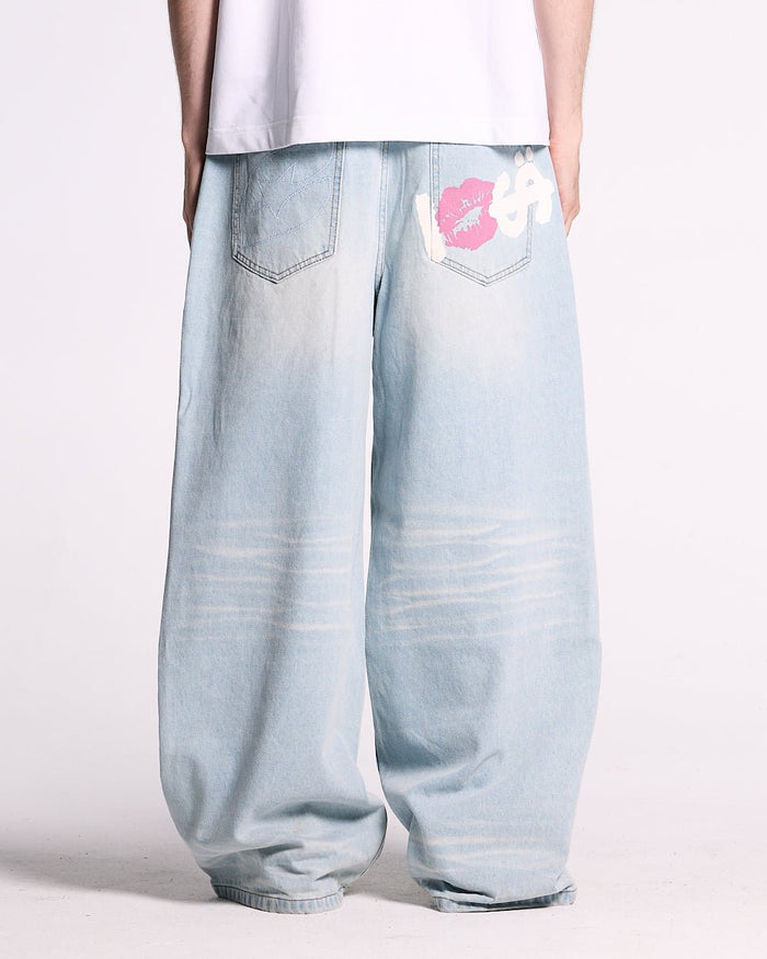 KISSES AND DOLLARS PANTS BLUE DENIM - light blue baggy denim pants, back view on male model - Cold Culture #man