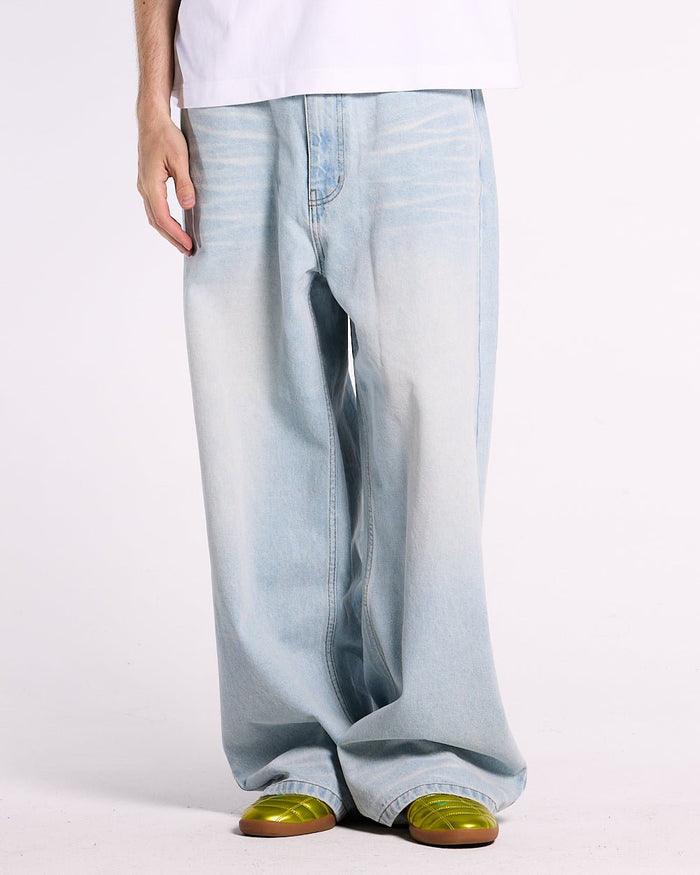 KISSES AND DOLLARS PANTS BLUE DENIM - light blue baggy denim pants, front view on male model - Cold Culture #man