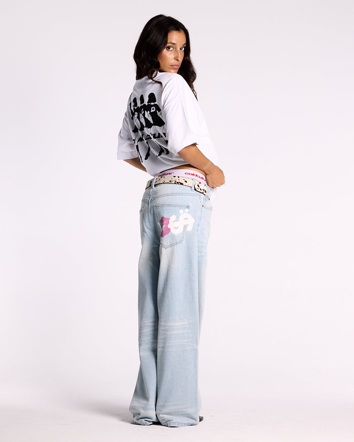 KISSES AND DOLLARS PANTS BLUE DENIM - light blue baggy denim pants, back view on female model - Cold Culture #woman