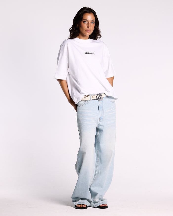 KISSES AND DOLLARS PANTS BLUE DENIM - light blue baggy denim pants, front view on female model - Cold Culture #woman