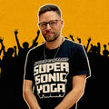Man wearing a 'Super Sonic Yoga' t-shirt with a yellow and black silhouette background