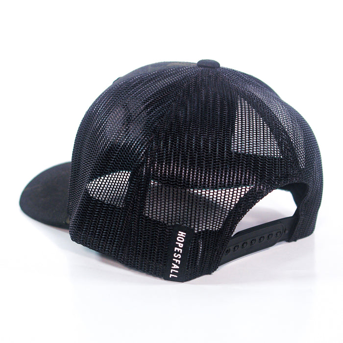 A black mesh Hopesfall trucker hat is shown with the back facing forward, highlighting the adjustable snapback strap and a Hopesfall label on the side. The front panel of the cap is partially visible.