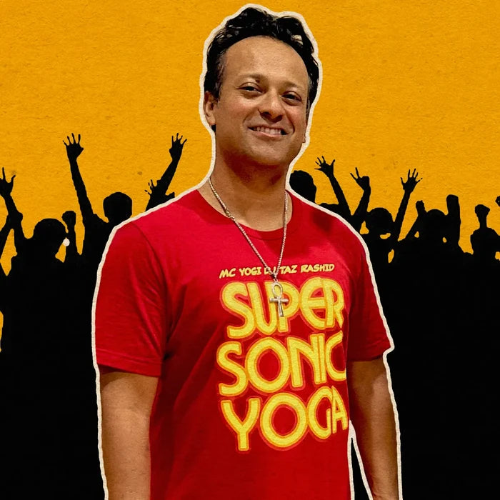 Man wearing a red 'Supersonic Yoga' t-shirt with a yellow text against a yellow and black silhouette background.