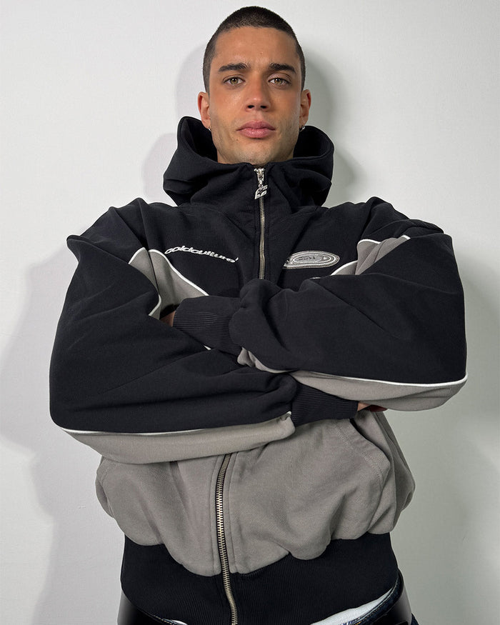 NO RISK ZIP HOODIE BLACK - black and grey colorblock zip-up hoodie, on model close-up - Cold Culture