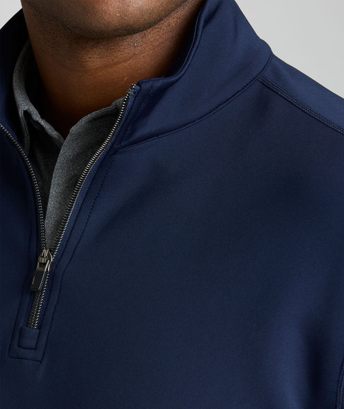 Model is wearing UNTUCKit performance sweatshirt in navy.