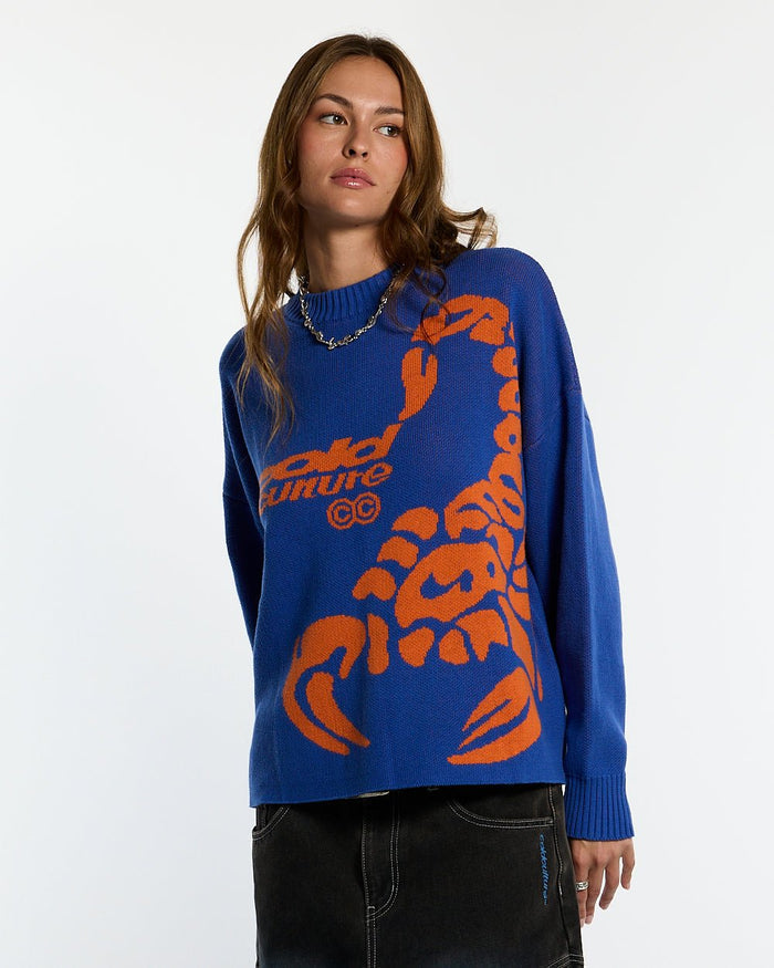 POISON KNIT BLUE AND ORANGE - blue graphic print knit sweater, front view on female model - Cold Culture #woman