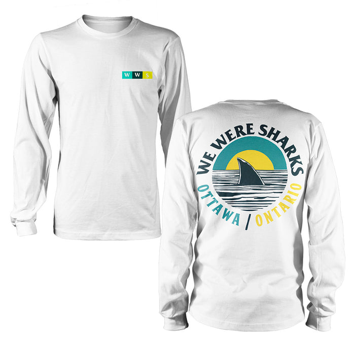 A white We Were Sharks long-sleeve shirt featuring a small front chest logo and a large back graphic with a shark fin, sunset, and the text WE WERE SHARKS OTTAWA / ONTARIO.