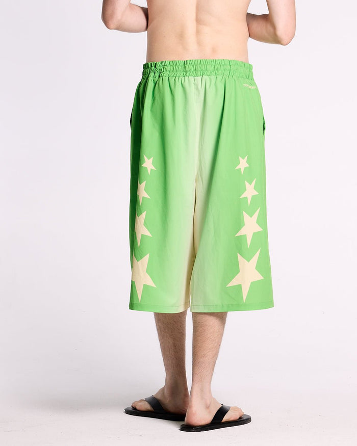 STARS WIDE SWIM SHORTS GREEN - green star print swim shorts, back view on male model - Cold Culture