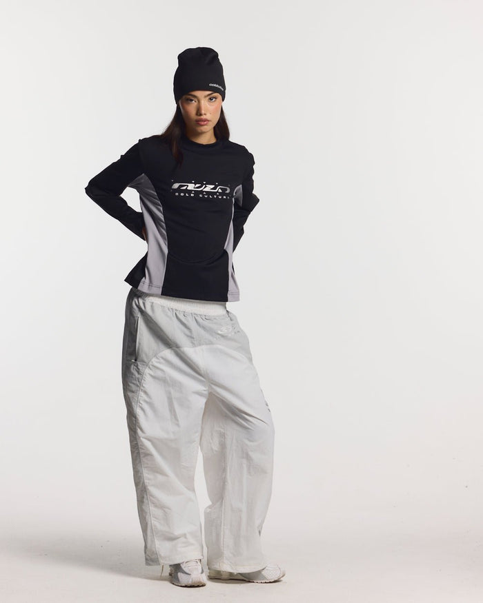 THUNDER PANTS LIGHT GREY - light grey nylon pants, front view on female model - Cold Culture #woman